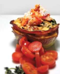 This image portrays Lobster Quiche with a Prosciutto Crust by California Diving News.